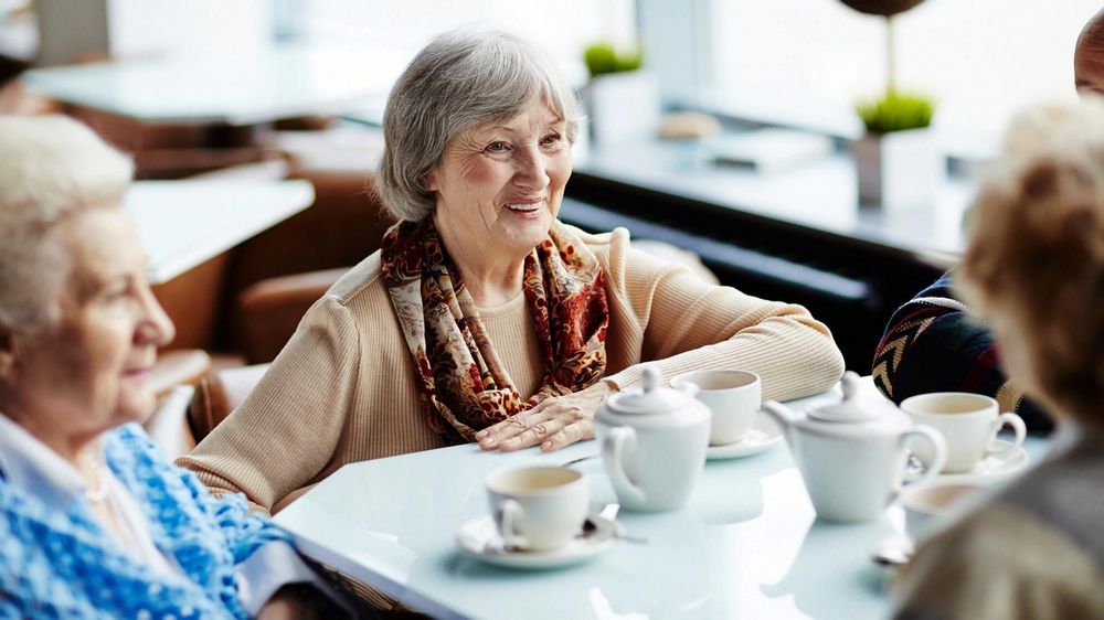 Пожилые женщины за столиком в кафе, чашки 